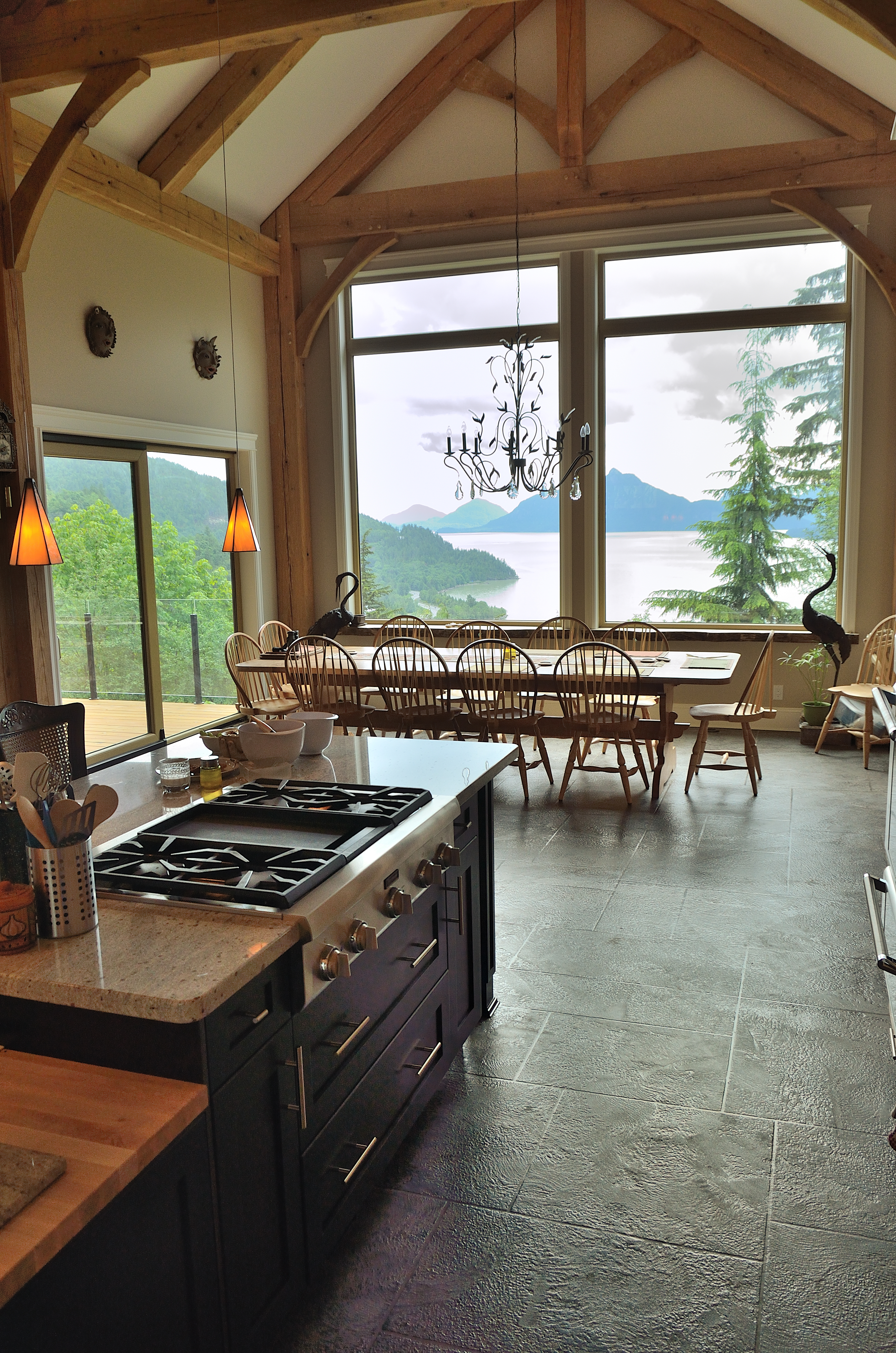 Luxury timber-frame kitchen with StoneCraft flooring overlooking BC waterfront
