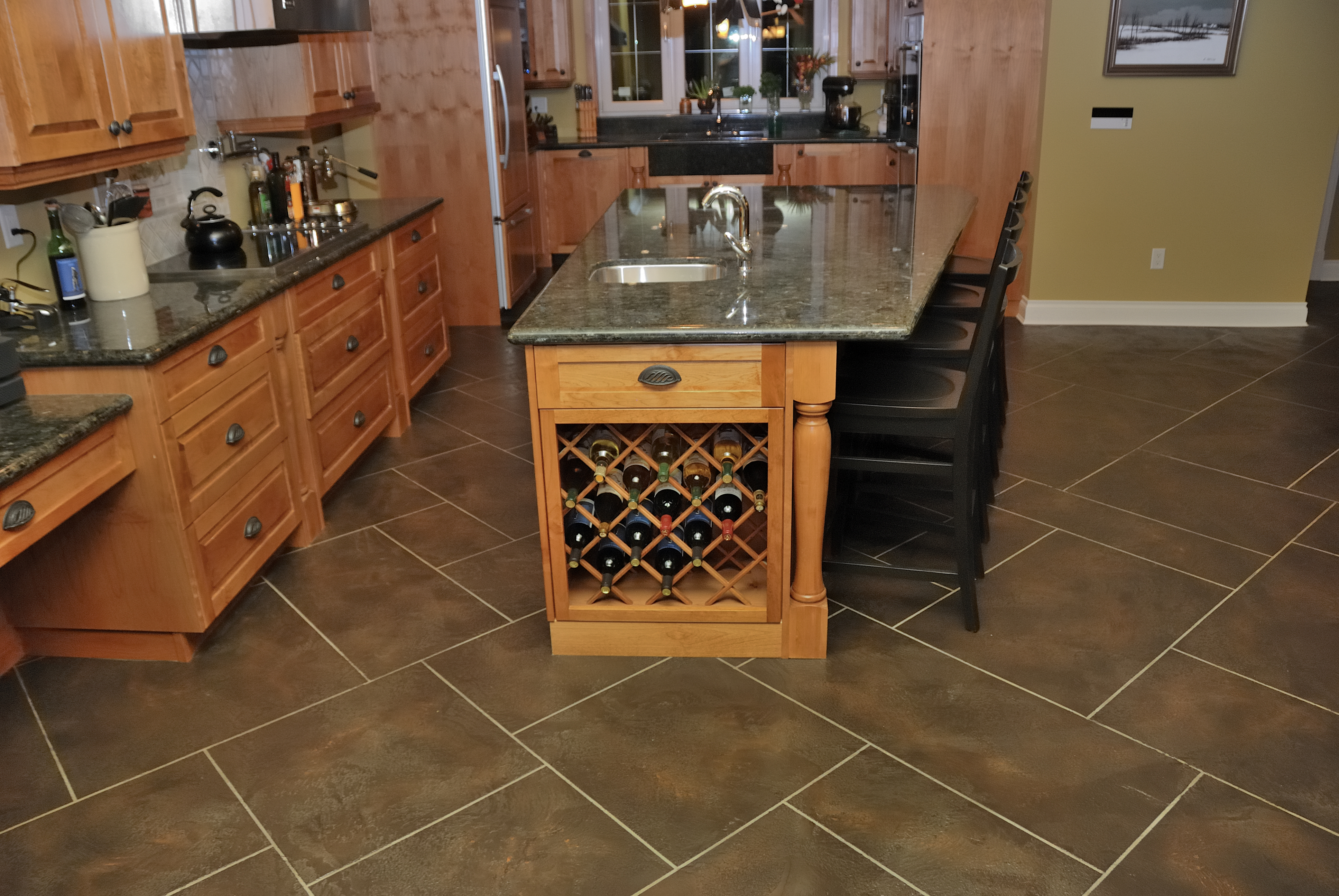 Residential kitchen with StoneCraft tile flooring and wine storage island