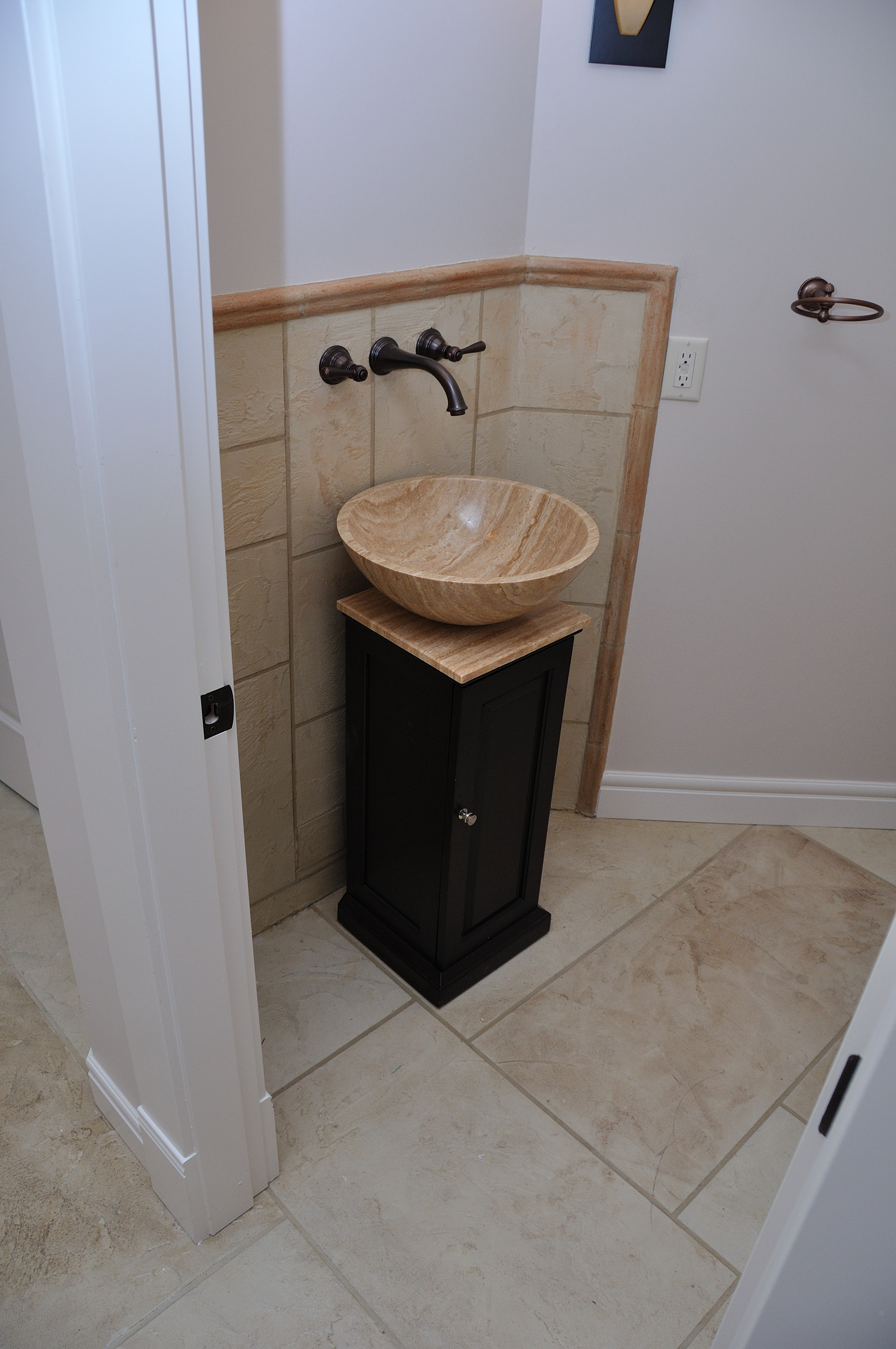 Residential powder room with vessel sink and StoneCraft tile