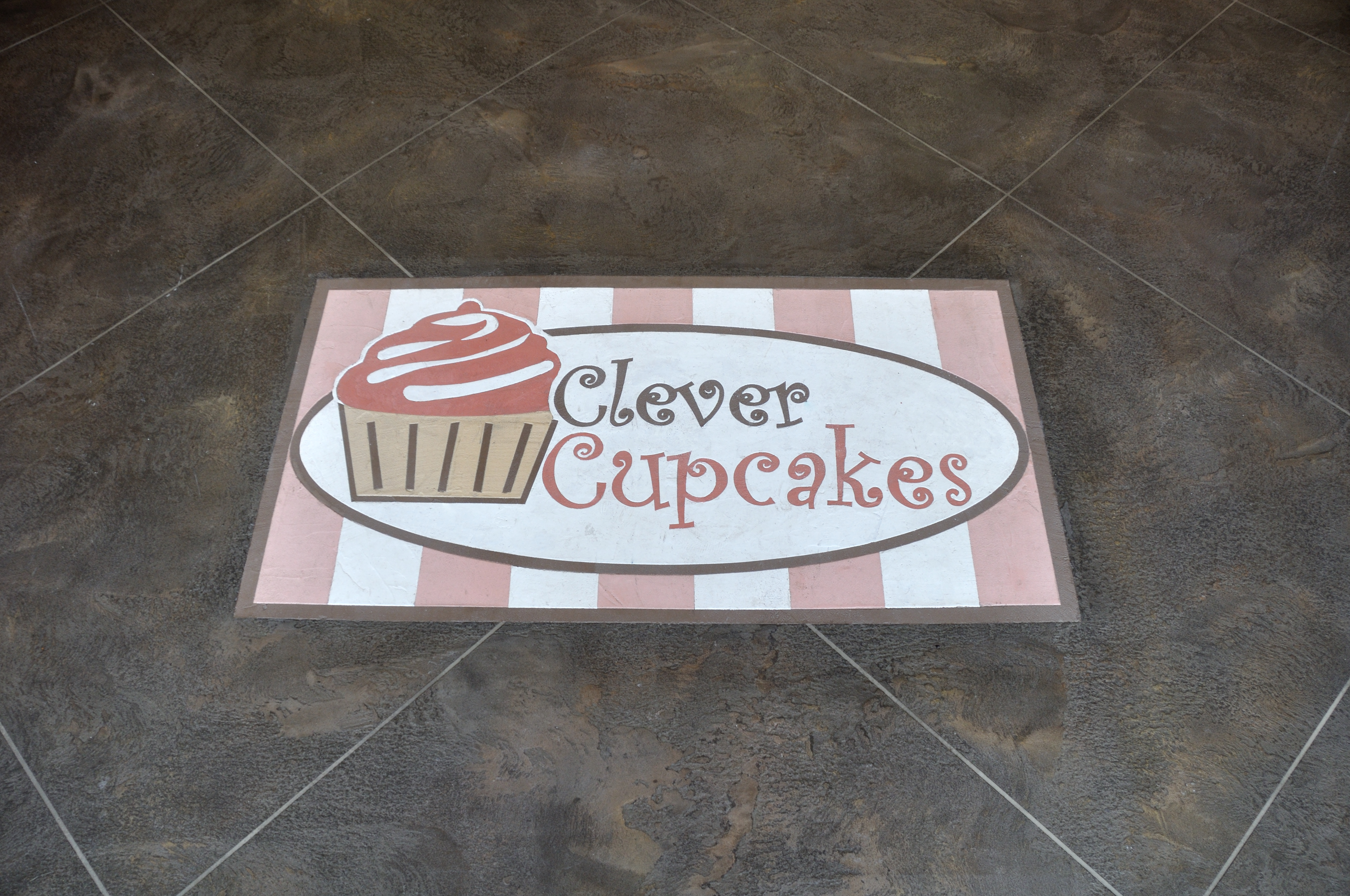 Close-up detail of custom Clever Cupcakes logo inlay